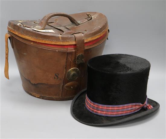 A Victorian top hat with leather case
